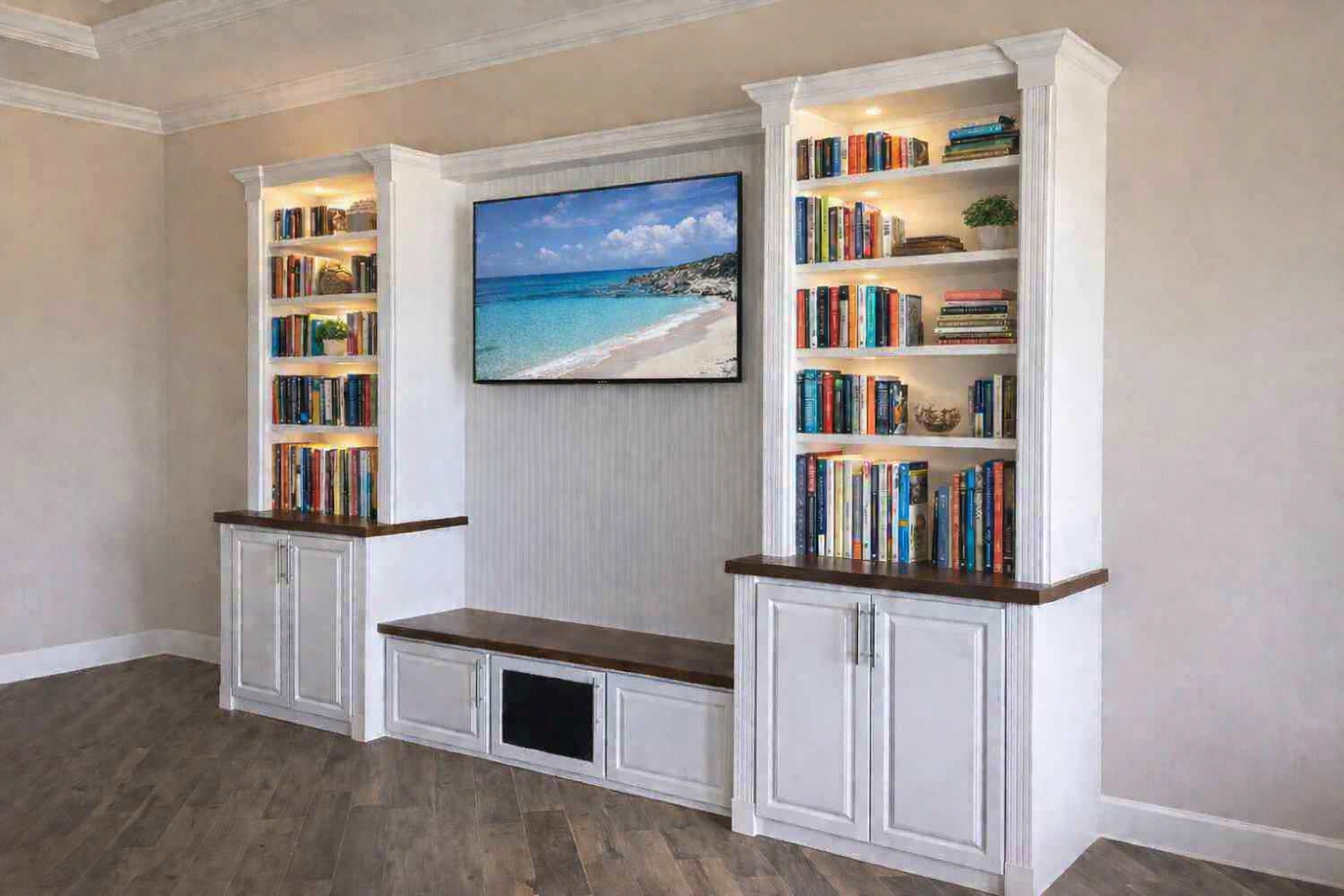 Built-in white bookshelves and a TV above a bench in a beige living room.