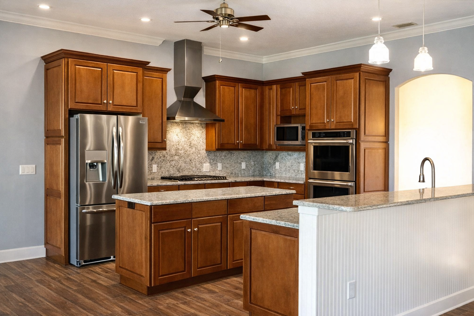 Modern kitchen with wood cabinets, stainless steel appliances, island, and granite countertops