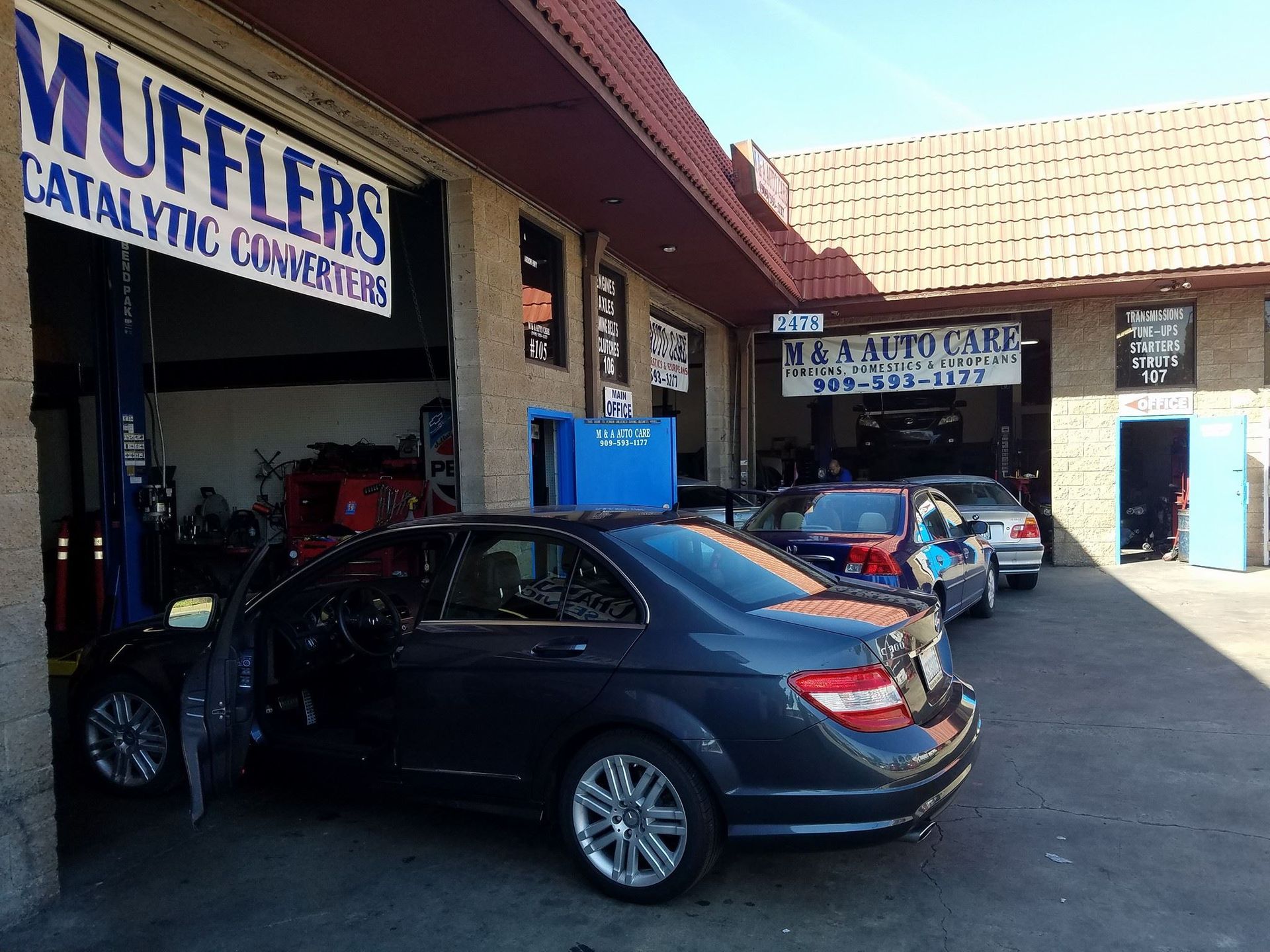 Dark car in auto repair shop with 