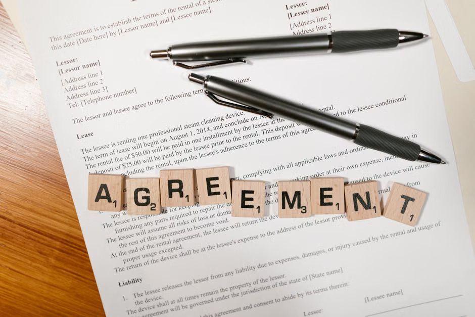 Business professionals reviewing a contract containing an arbitration agreement clause for faster dispute resolution outside of court.
