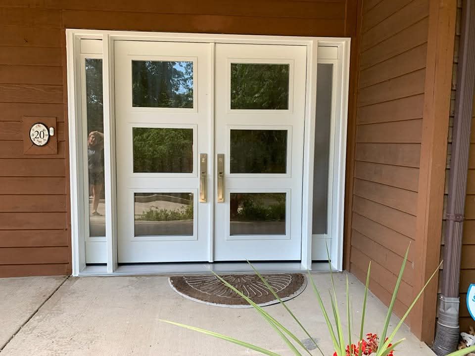 White double doors with glass panels; entry to a building.