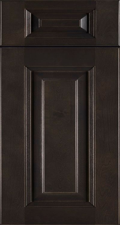 Dark brown cabinet door with a raised panel design and a small drawer above it
