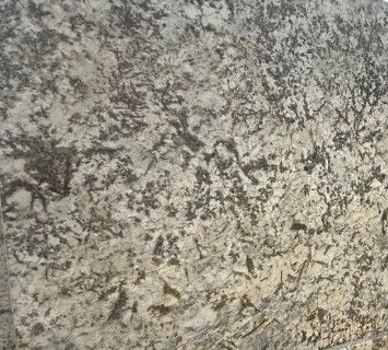 Gray and black speckled stone surface with a rough, mottled texture