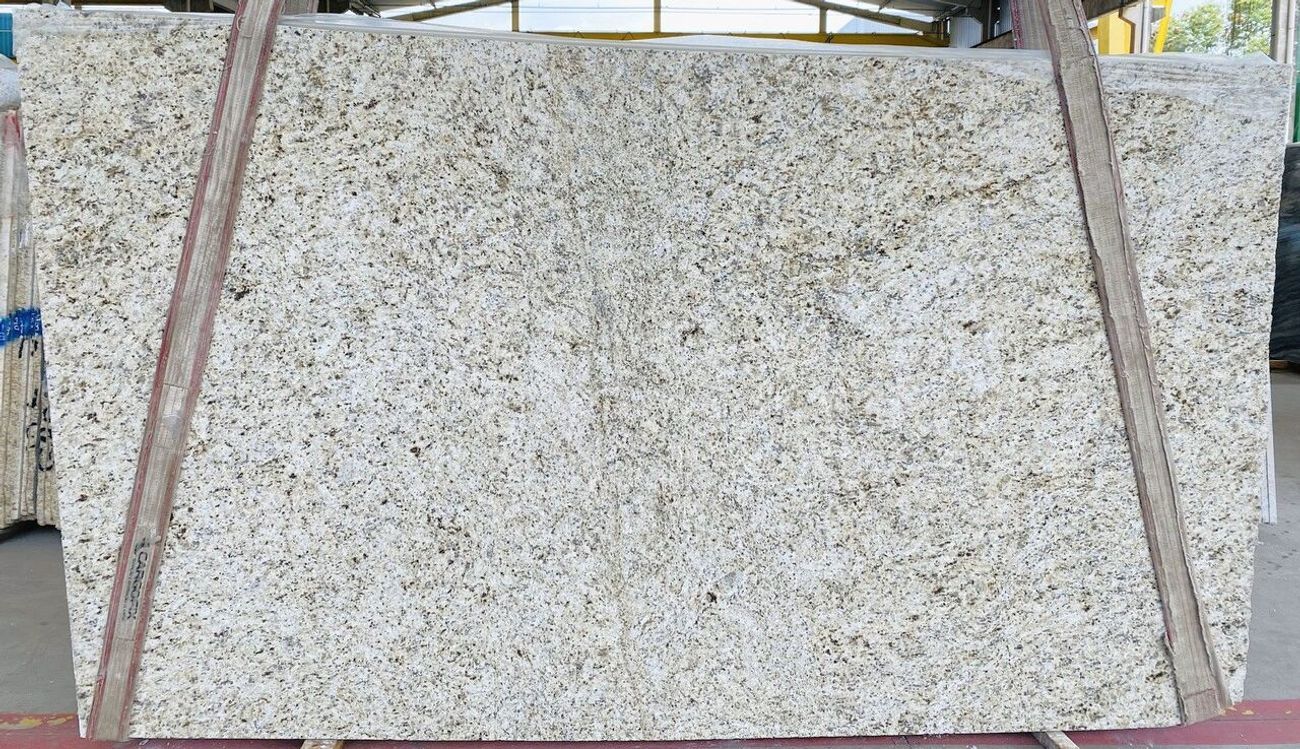 Large speckled stone slab leaning upright, supported by wooden braces outdoors