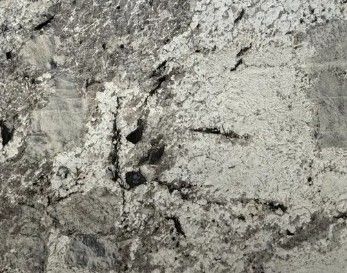 Rough gray stone surface with dark cracks and streaks
