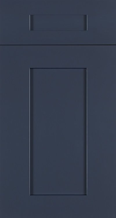 Dark blue paneled cabinet door with a small top drawer handle.