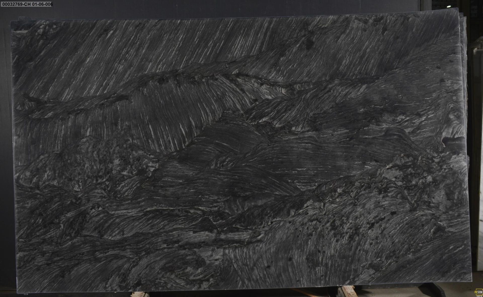 Dark slate board with chalky white scribbles and smudges, filling the frame.