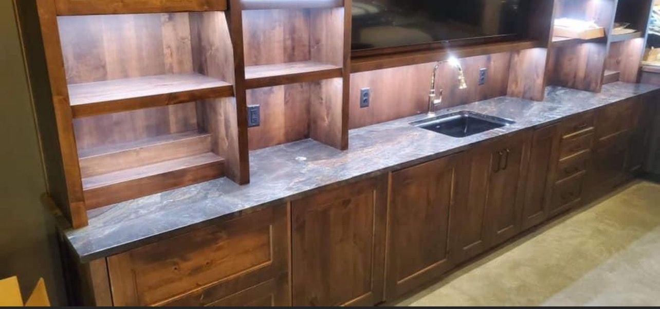 Wooden kitchen cabinets and counter with built-in sink and open shelving
