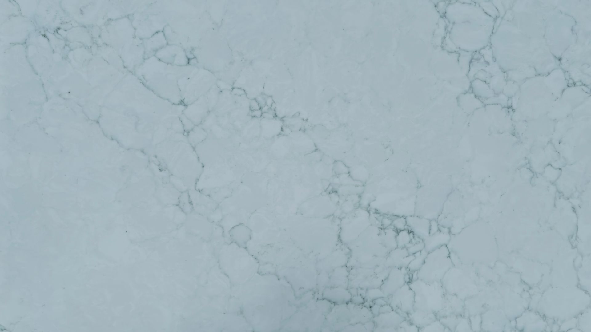 Light blue marble-like surface with faint gray veining