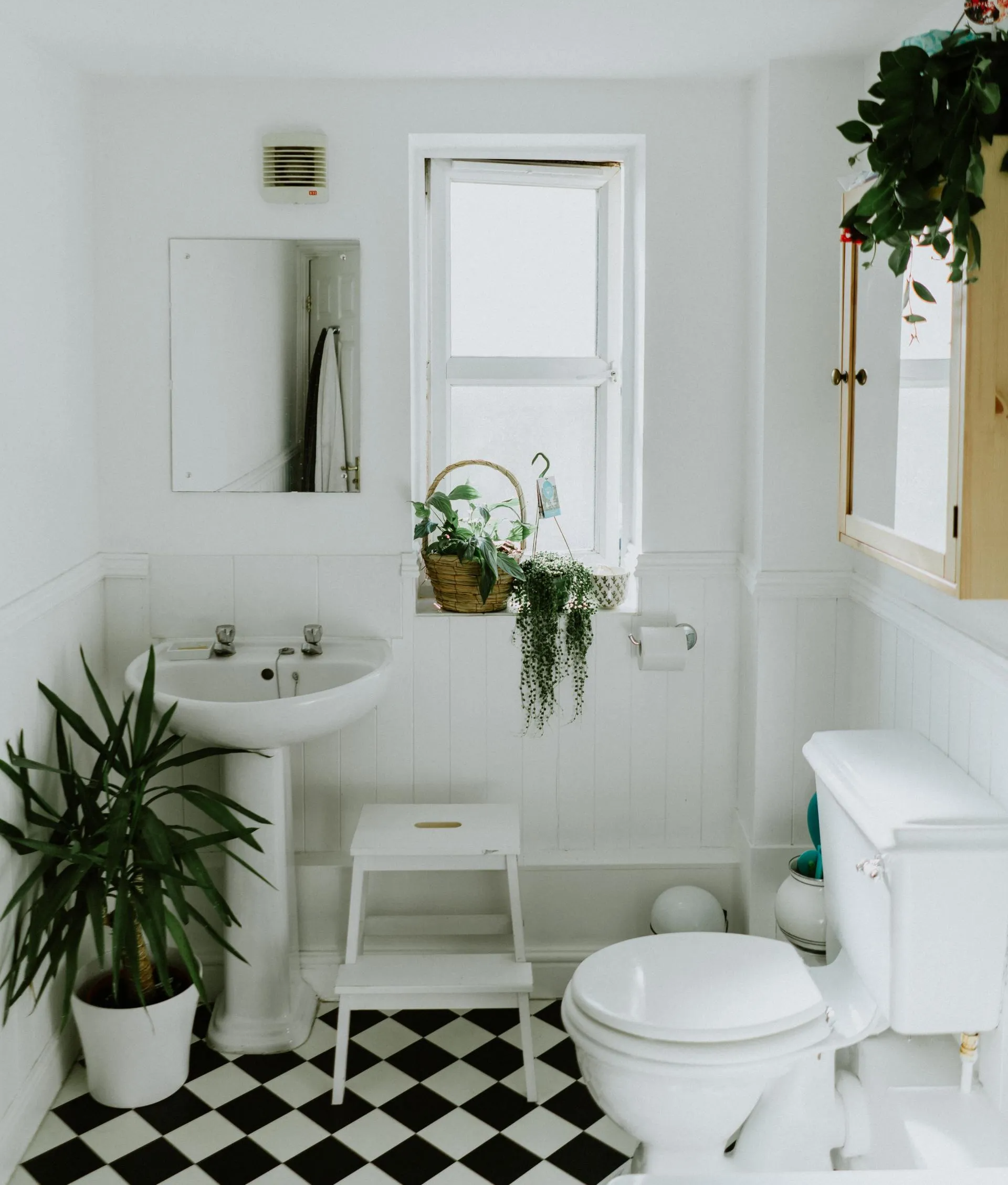 A bathroom with a black and white checkered floor