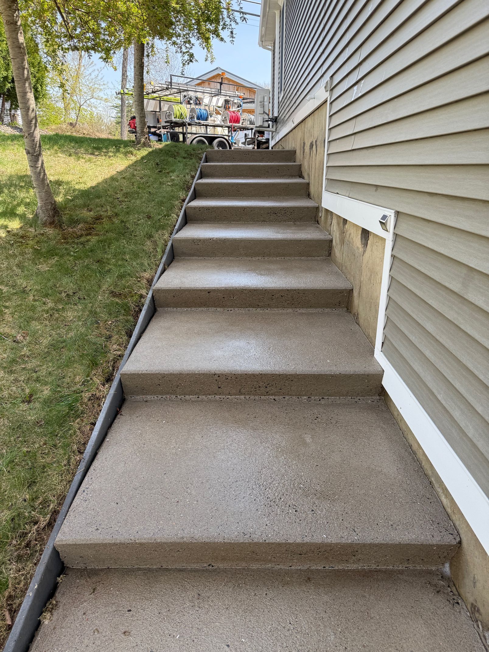 A set of concrete stairs leading up to a house.