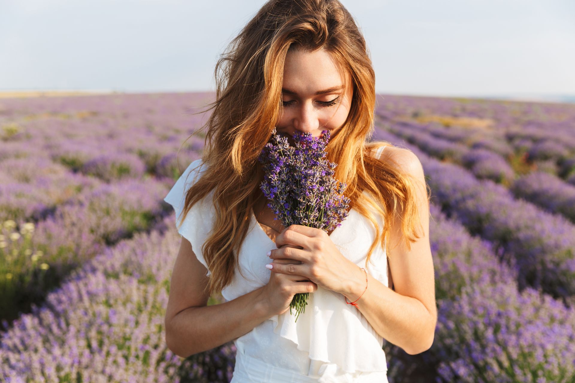 Woman smelling a bouquet of lavender
