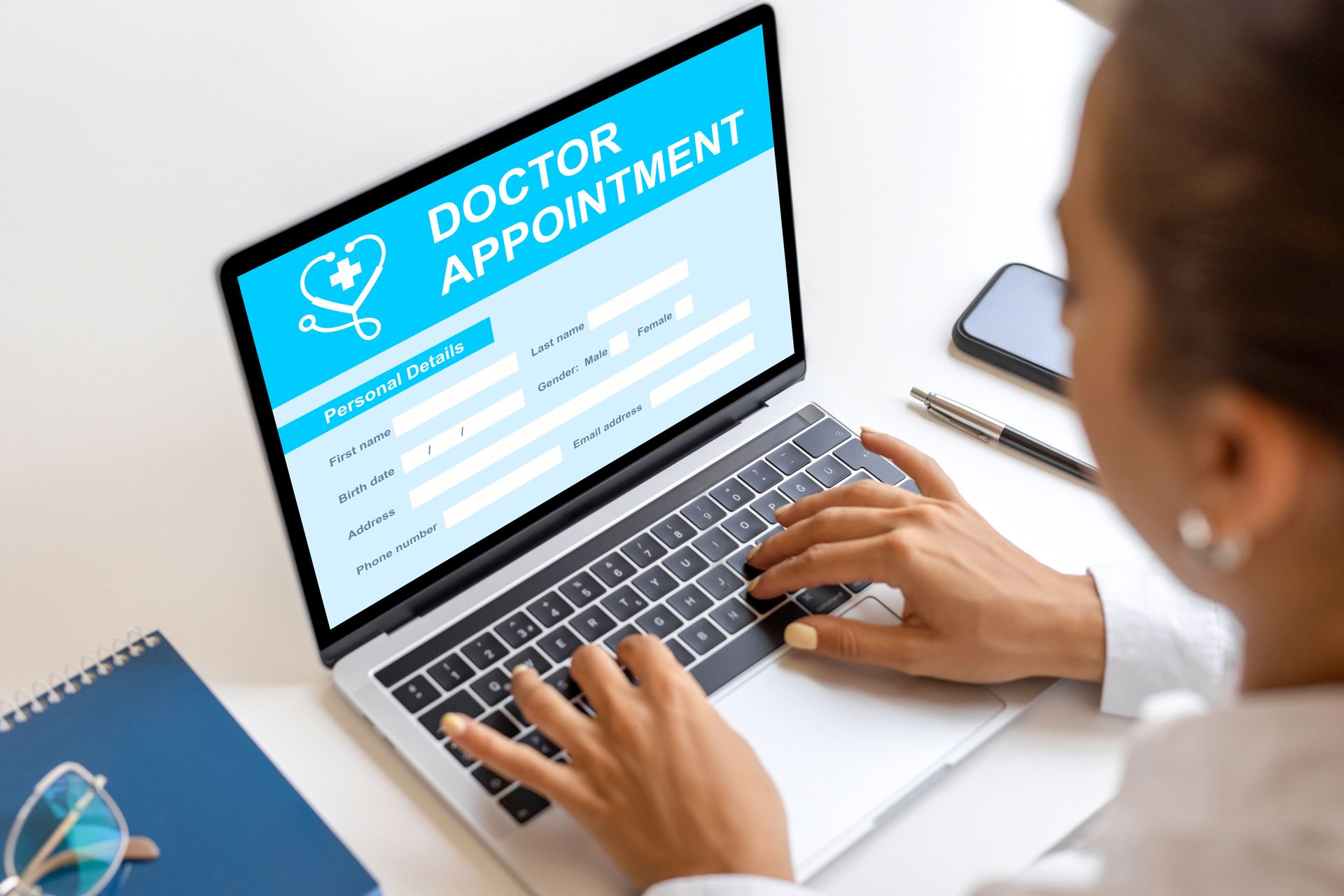 Doctor typing on a laptop