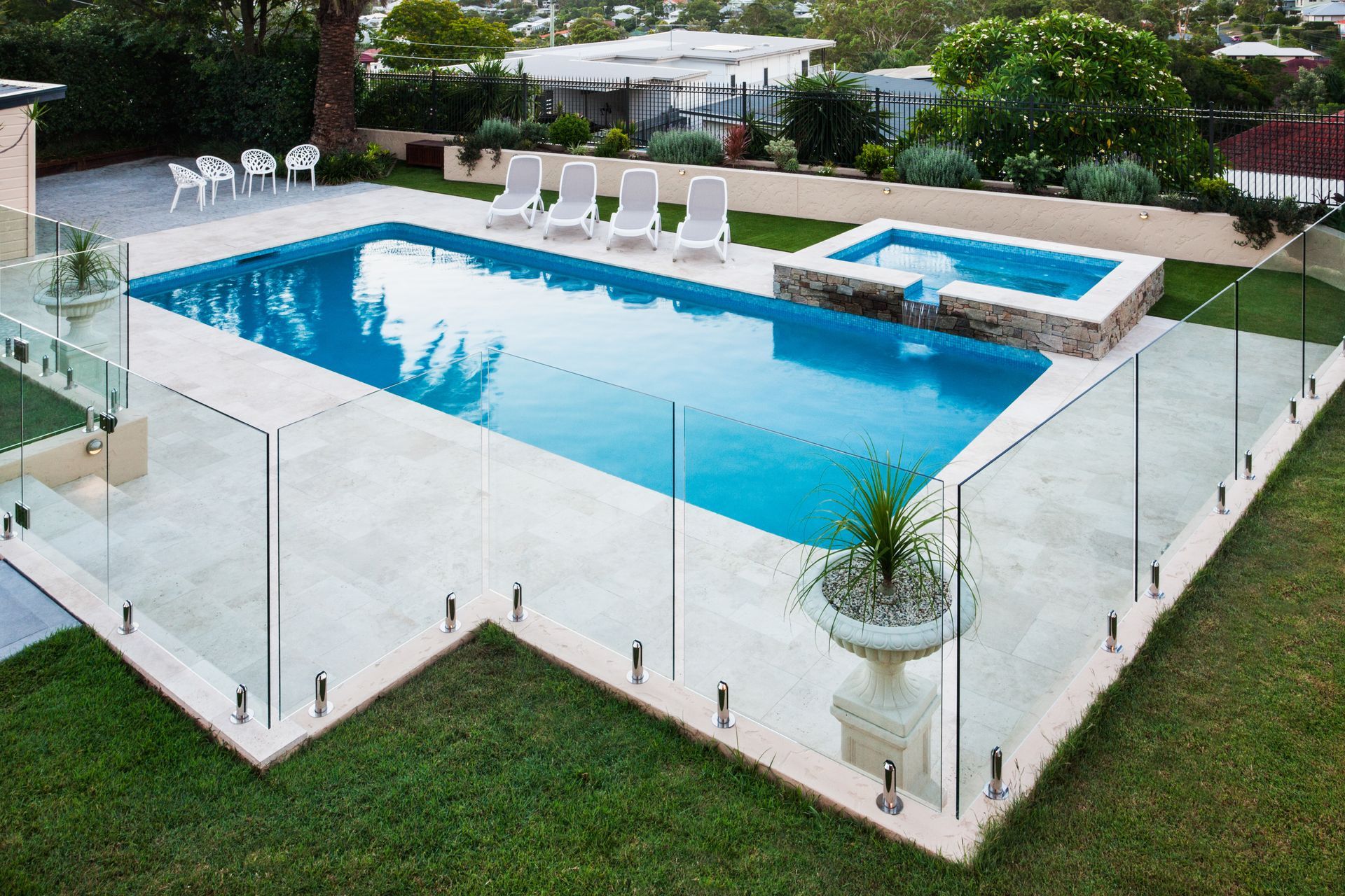 Modern swimming pool covered with glass panels besides a lawn. Modern swimming pool covered with glass panels besides a lawn.