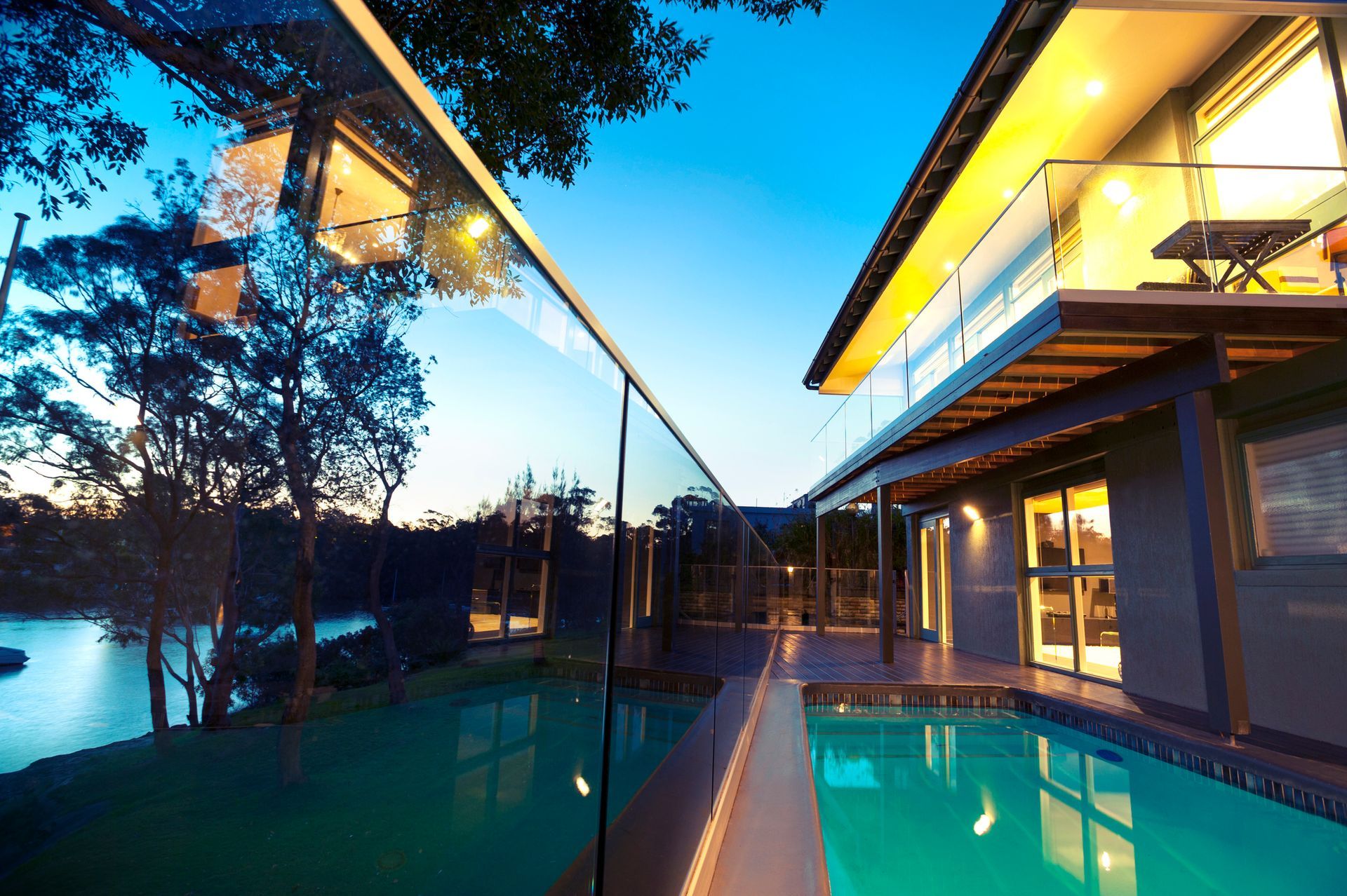 A swimming pool with a glass fence.