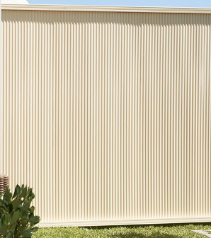 Tan vertical ribbed siding on a building wall.