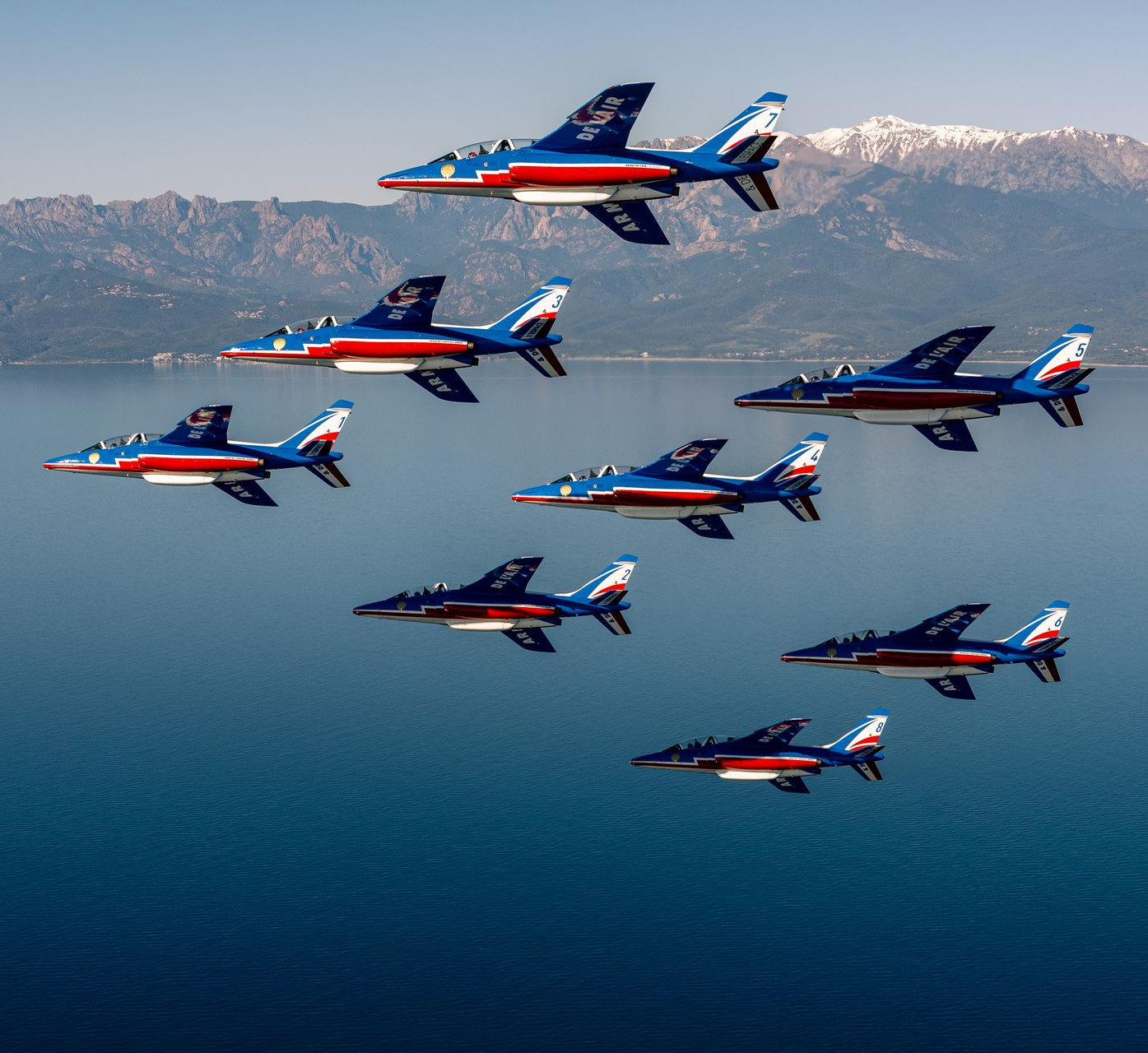 Four us navy fighter jets are flying in formation