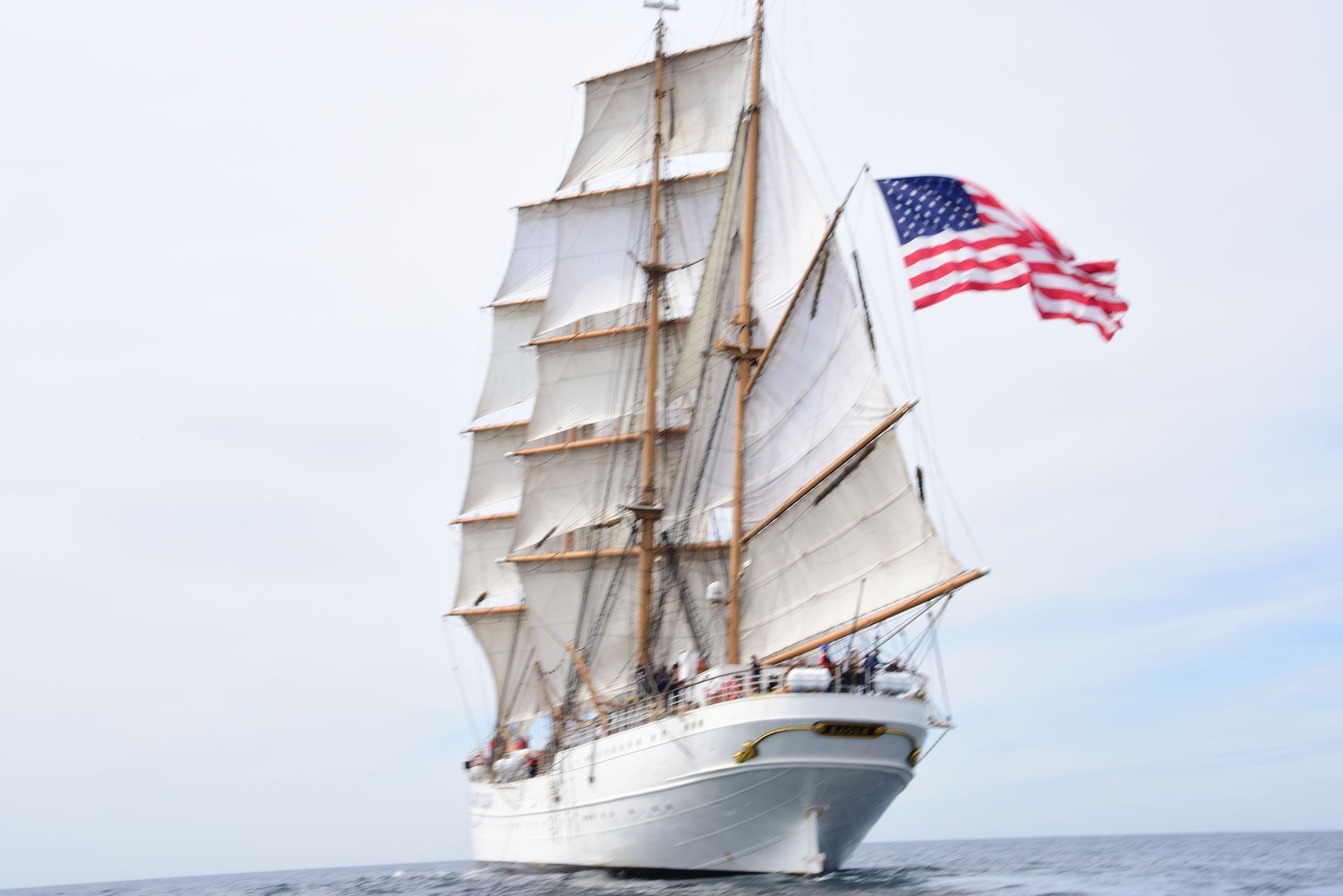 A sailboat with an american flag on top of it