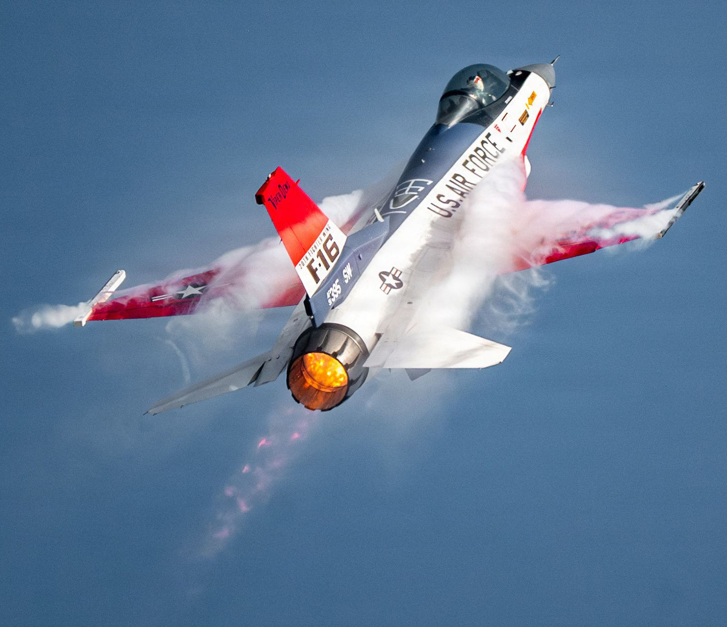Four us navy fighter jets are flying in formation