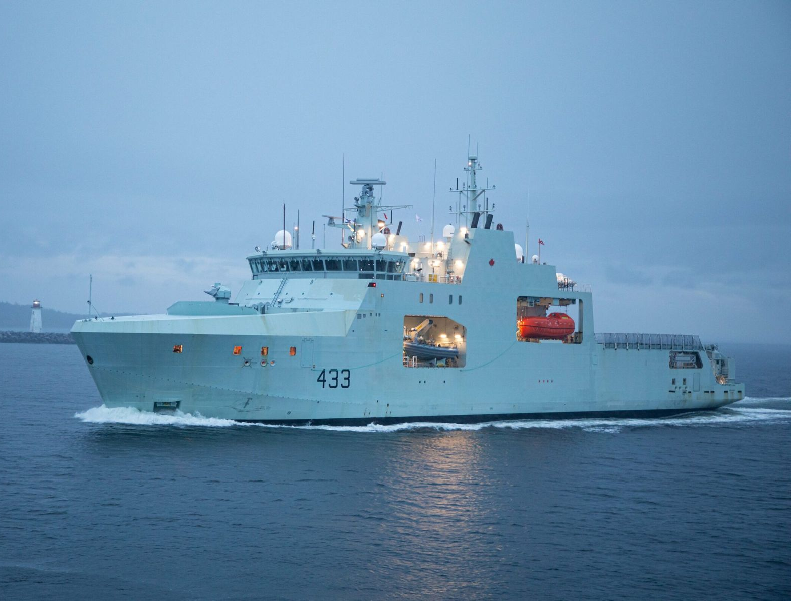 A large ship is floating on top of a body of water.