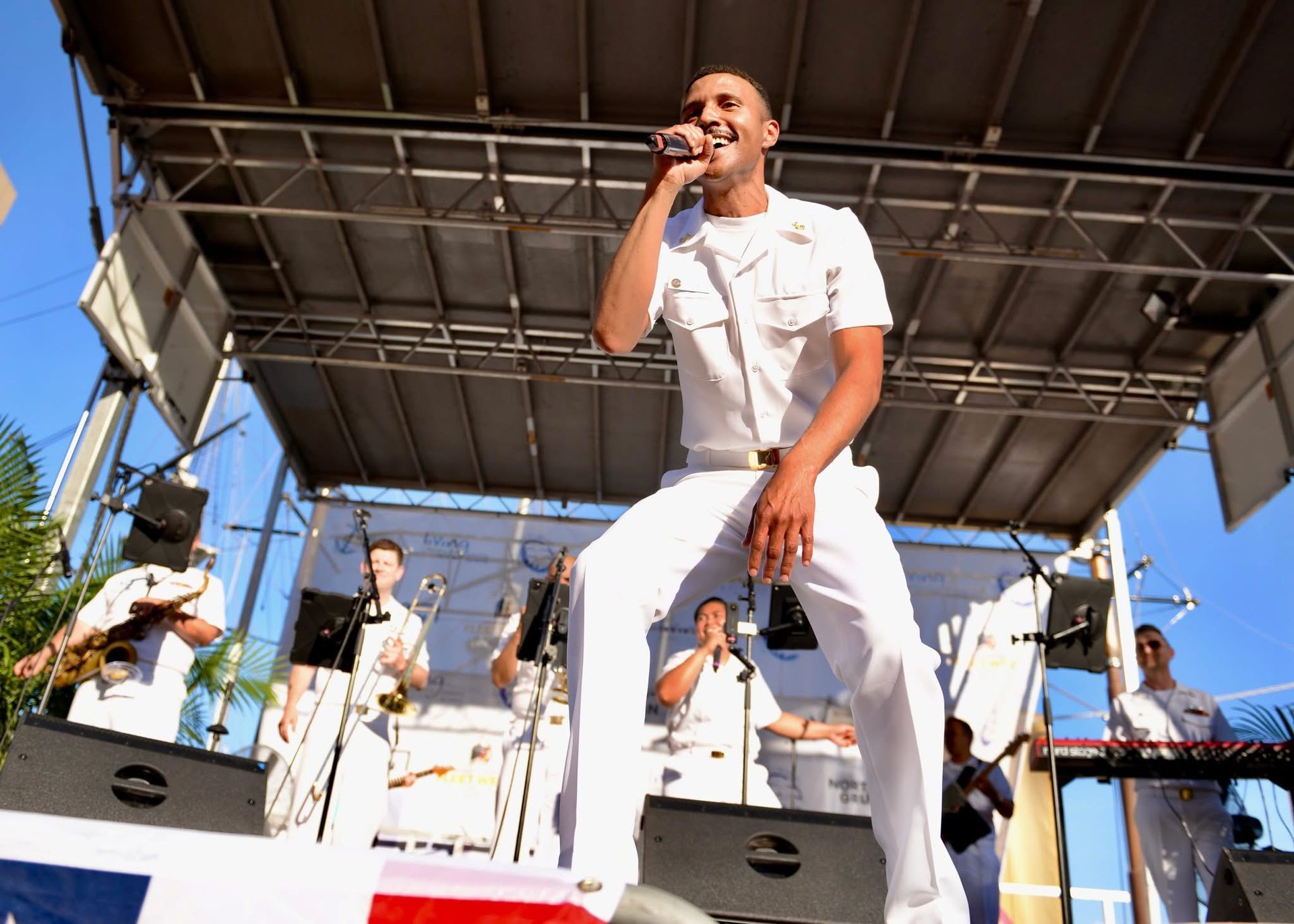A man singing into a microphone on a stage