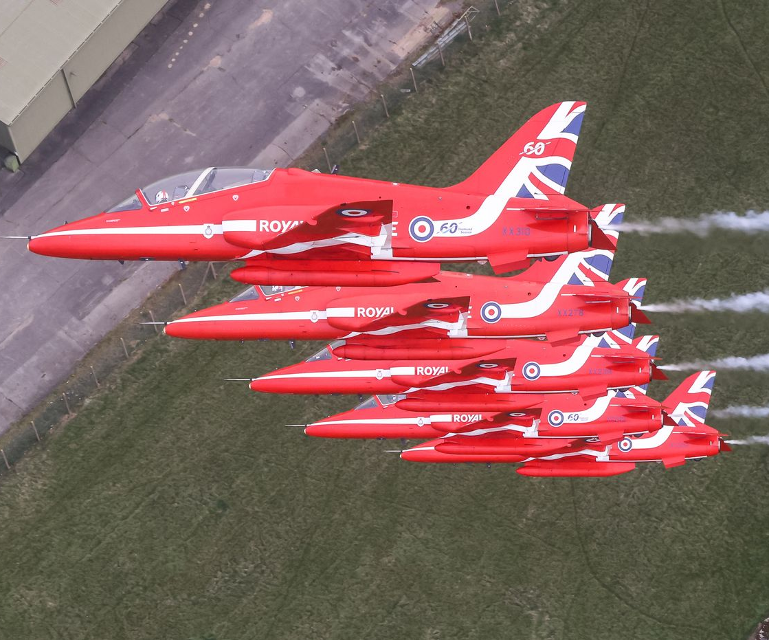 Four us navy fighter jets are flying in formation