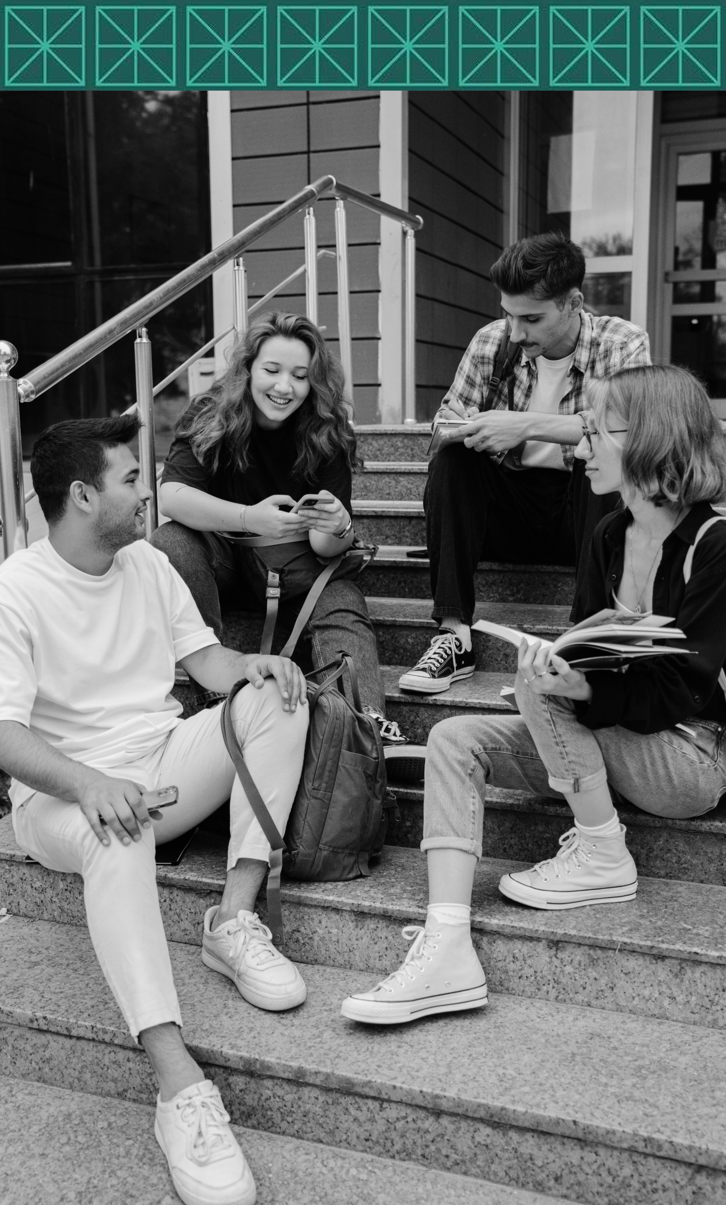 A group of young people are sitting on the steps of a building.