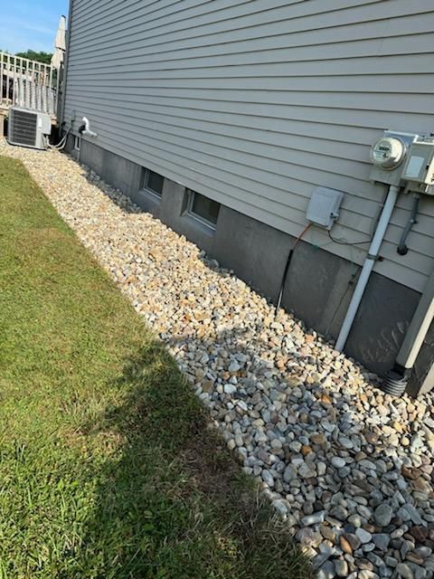 A house with a lot of rocks on the side of it.