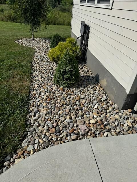 A house with a lot of rocks in front of it