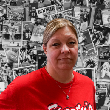 A woman wearing a red shirt with the word rookie on it