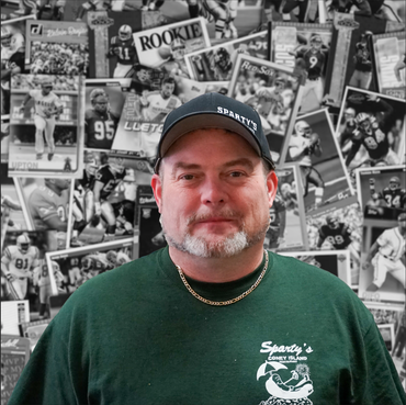 A man wearing a spartans hat and a green shirt