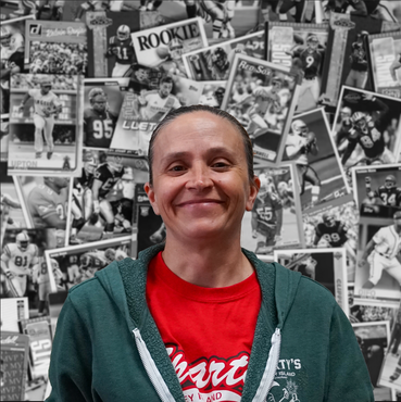 A woman wearing a green hoodie and a red shirt with the word smart on it
