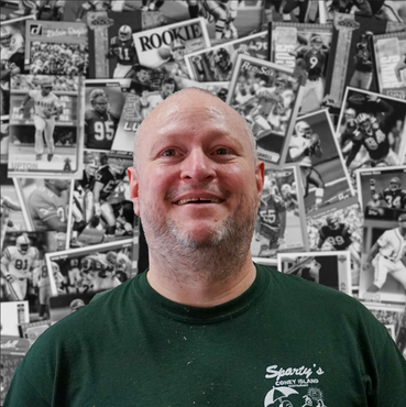 A man wearing a green shirt with the word rookie on it