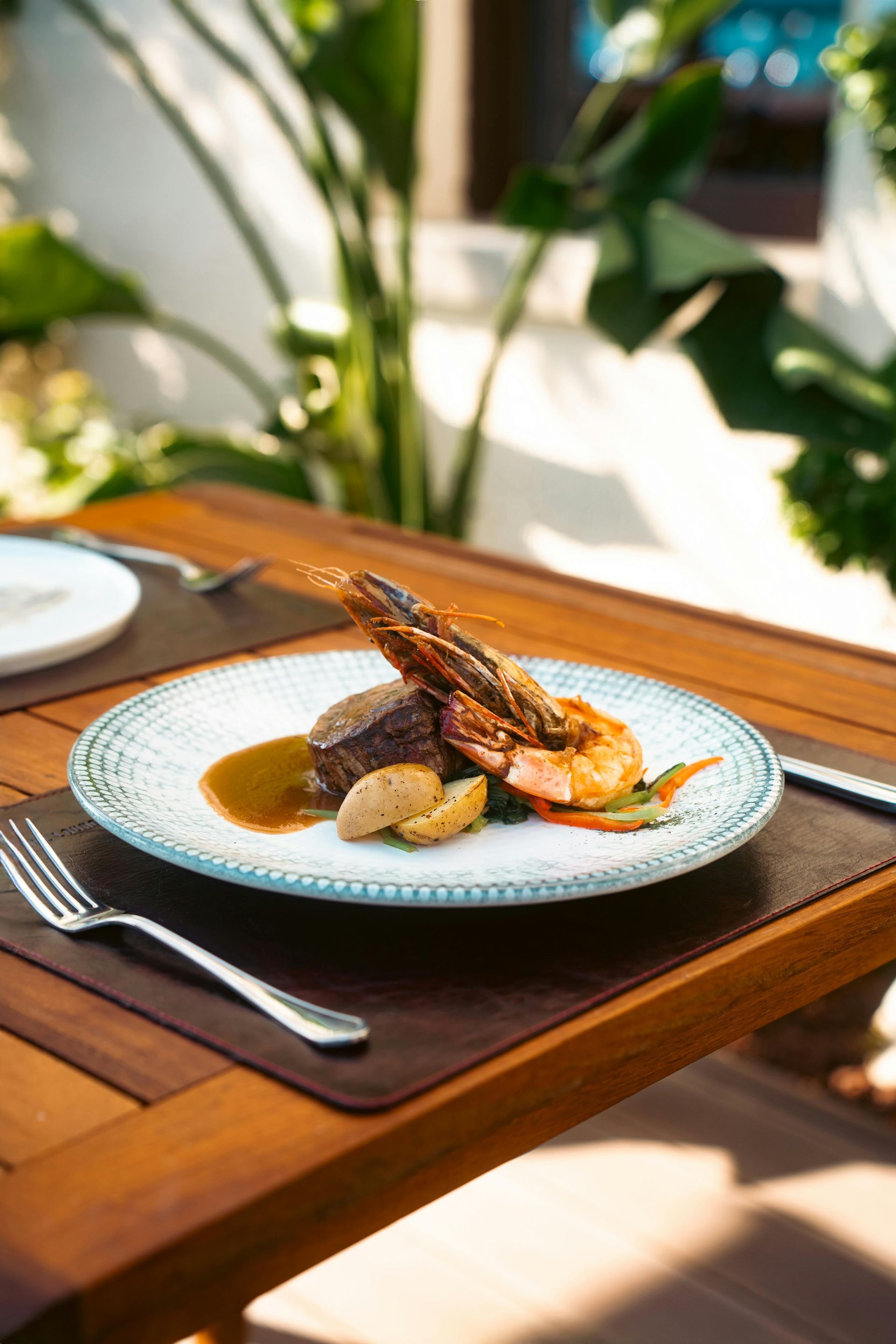 A plate of food is sitting on a wooden table.