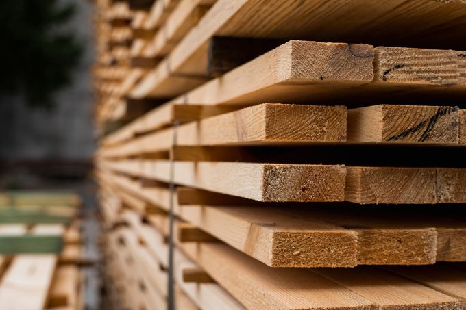 Piles of wooden boards in the sawmill, showcasing construction materials