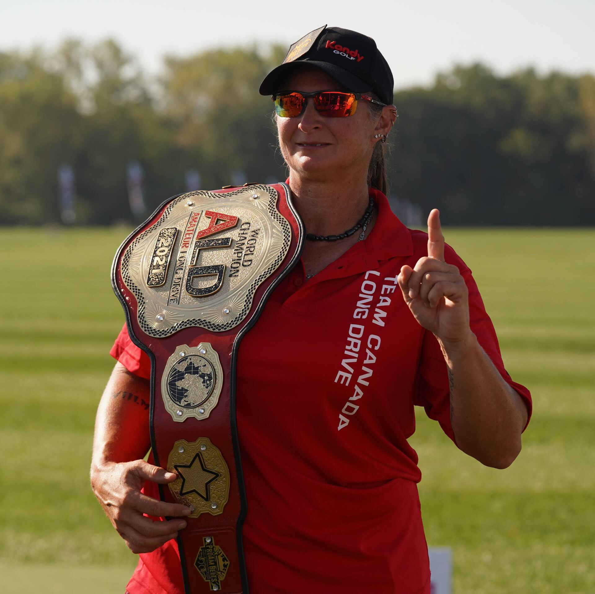 A woman wearing a red shirt that says long drive on it