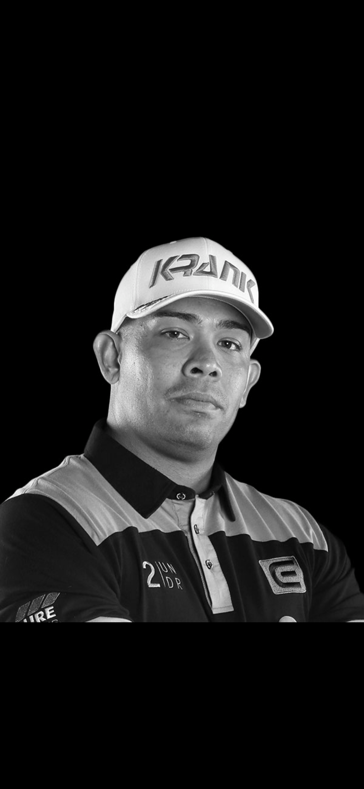 A black and white photo of a man wearing a hat.