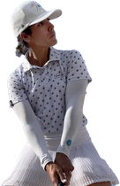 A woman wearing a white hat and a white shirt is holding a golf club.