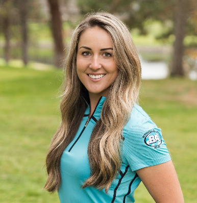 The woman is wearing a blue shirt and smiling for the camera.