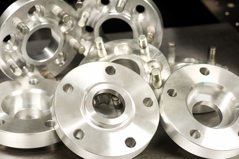 A Bunch Of Aluminum Wheels Are Sitting On A Table — Antons Recycling In Ciccone, NT