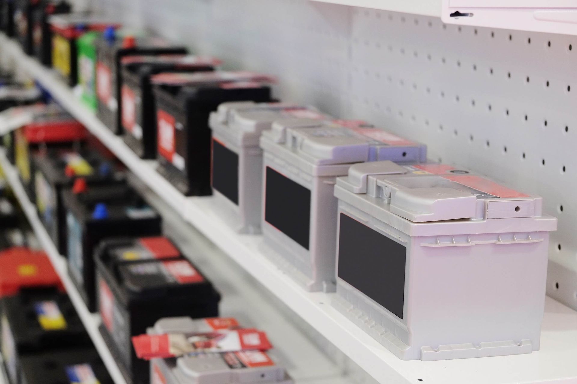 A shelf filled with a variety of batteries in a store — Antons Recycling In Ciccone, NT
