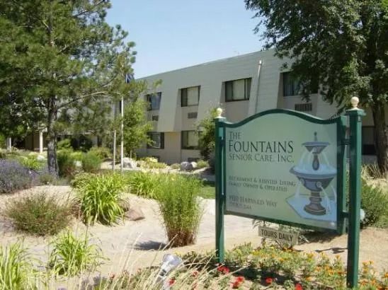 A sign for the fountains senior care inc. is in front of a building