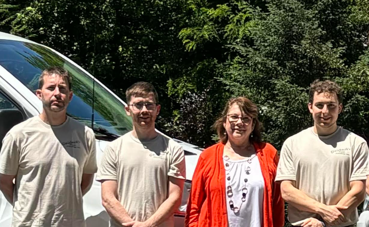 A group of people standing next to each other in front of a van Galebach’s Floor Finishing