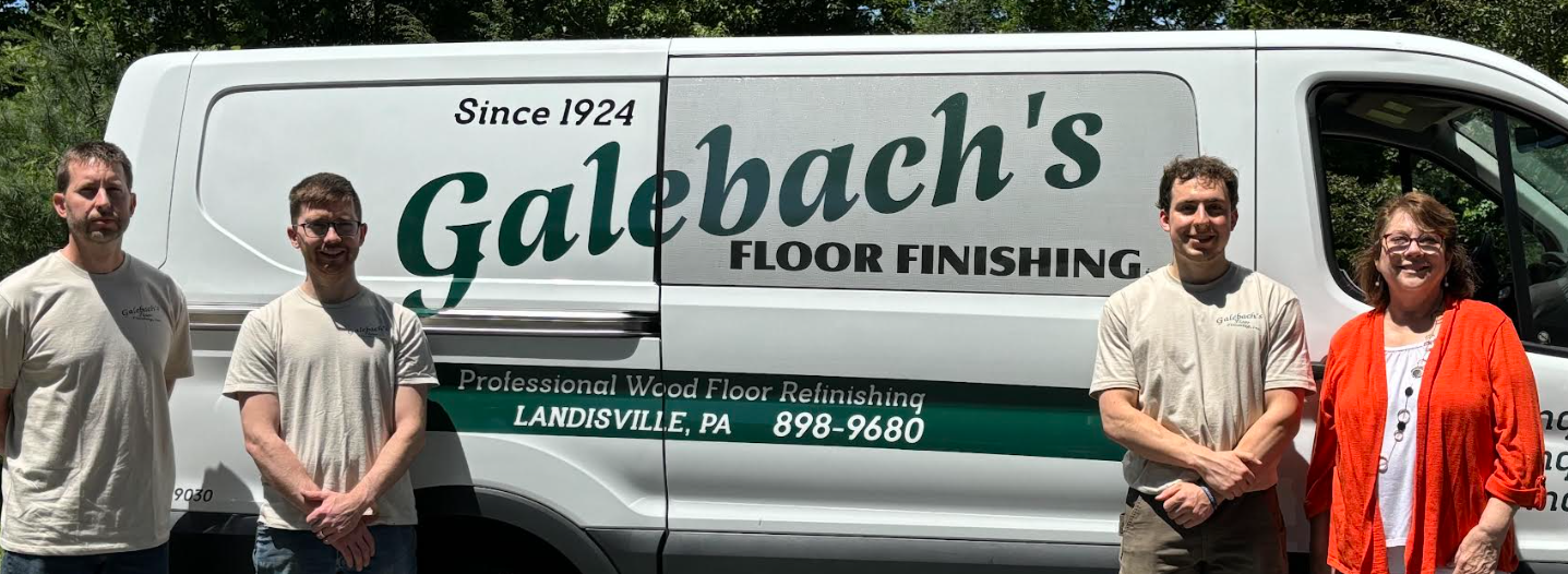 A group of people standing in front of a Galebach’s Floor Finishing van