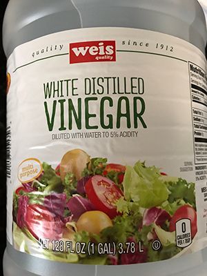 A bottle of white distilled vinegar with a picture of a salad on the label.