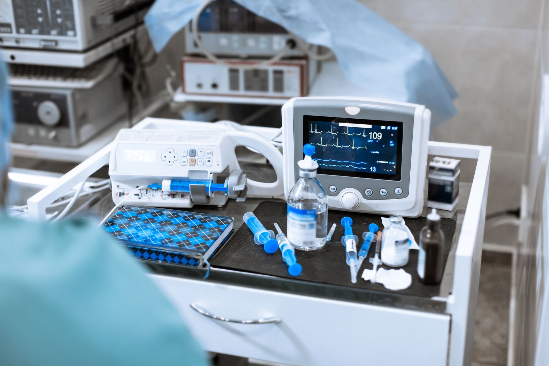 A surgical table with a monitor , syringes , and other medical equipment.