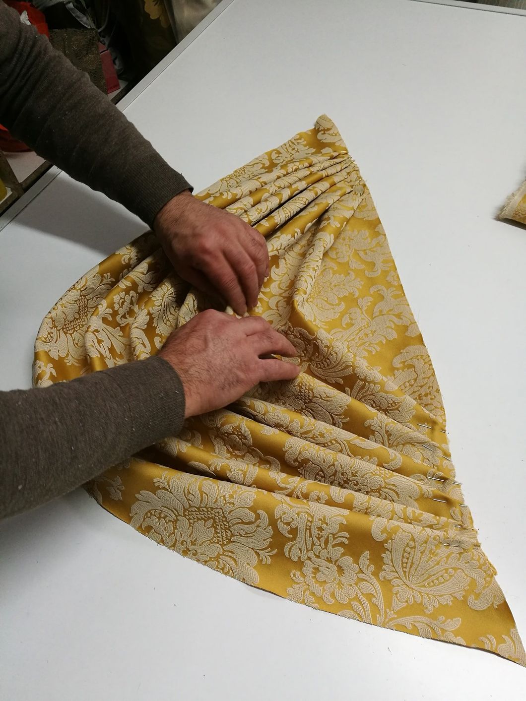 Una persona sta piegando un pezzo di stoffa in un triangolo
