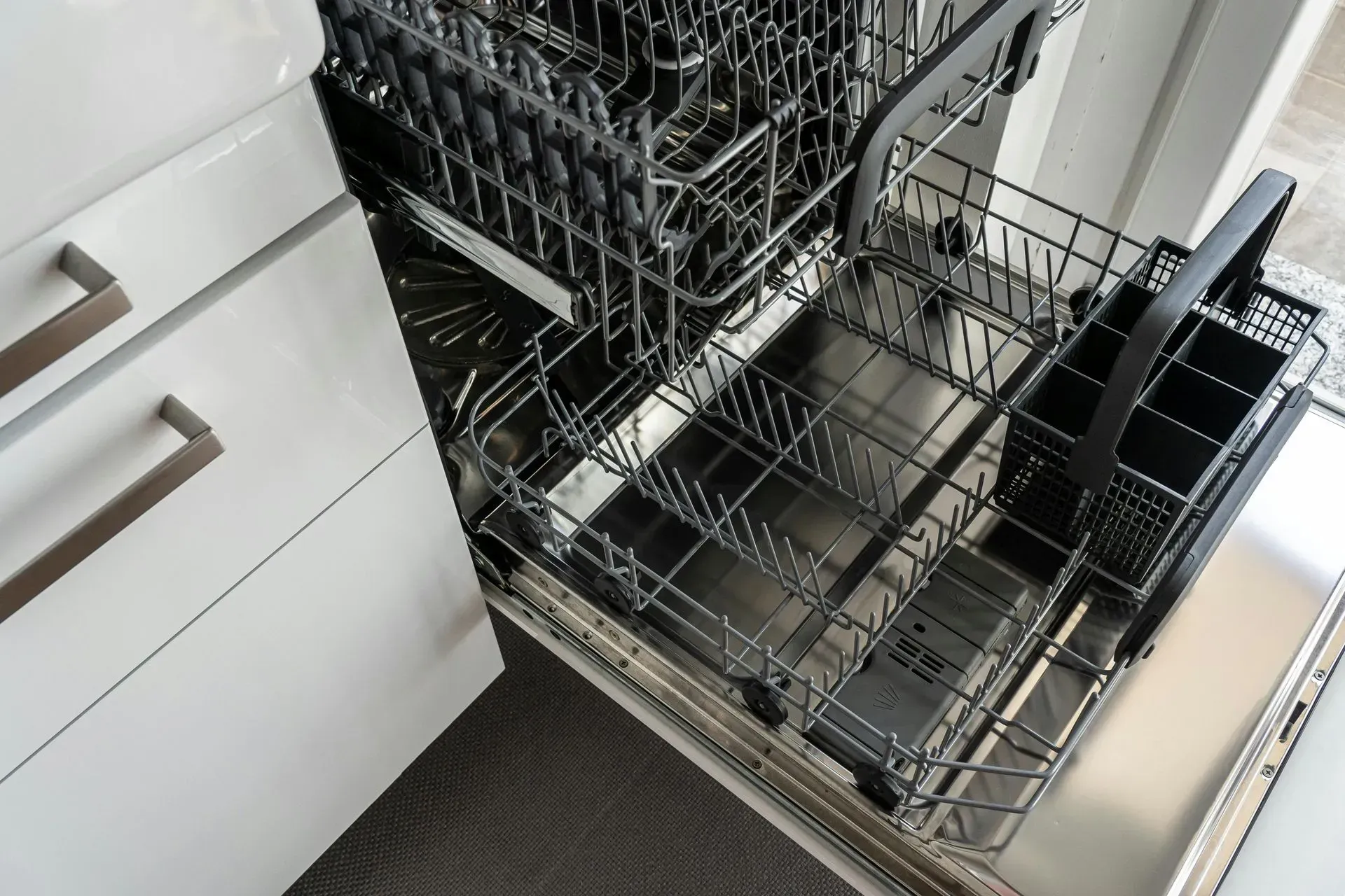 Refrigerator compressor repair with tools on a tiled floor; gauges, pliers, hammer.
