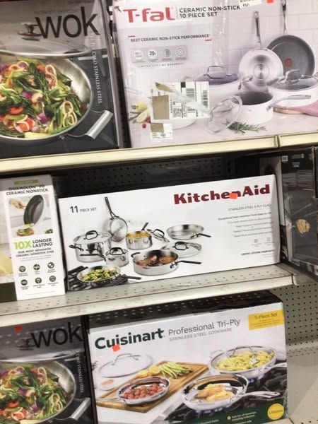 A shelf with boxes of pots and pans on it