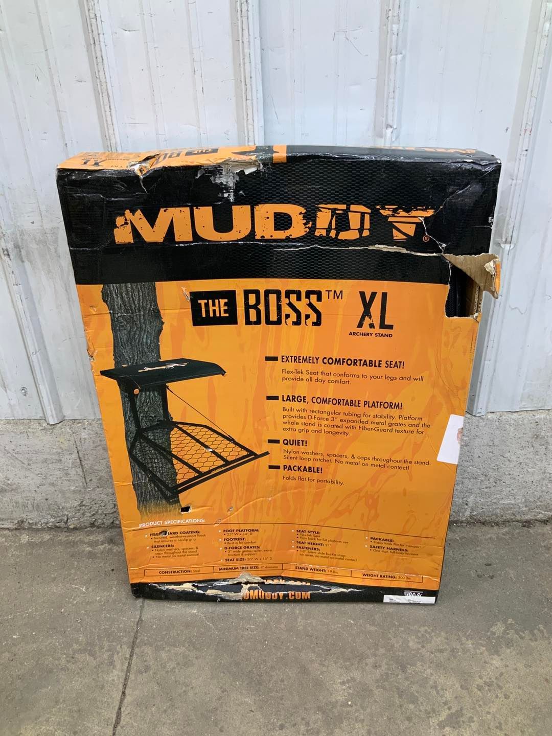 A muddy boss xl tree stand is in a box